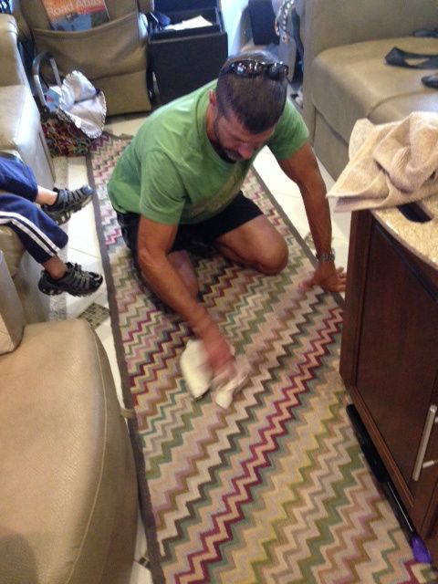 Shawn using white wine to get our red wine stain out of our carpet. 